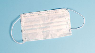 inside out disposable mask on light blue background